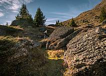 At the wayside, there are imposing boulders on which the pioneers of alpine vegetation unfold their discreet blaze of colour: lichens. (bei Klick vergrösserte Ansicht Bild)